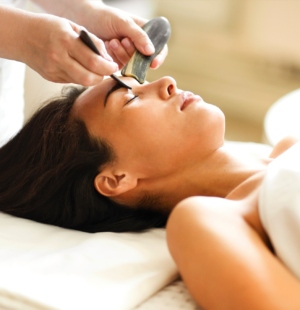 Face massage or beauty treatment for asian woman in spa salon