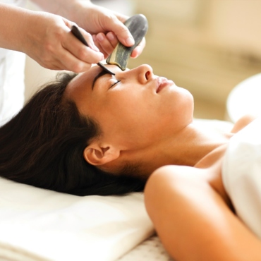Face massage or beauty treatment for asian woman in spa salon
