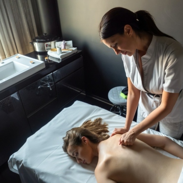 Woman having massage of body in the spa salon. Beauty treatment concept