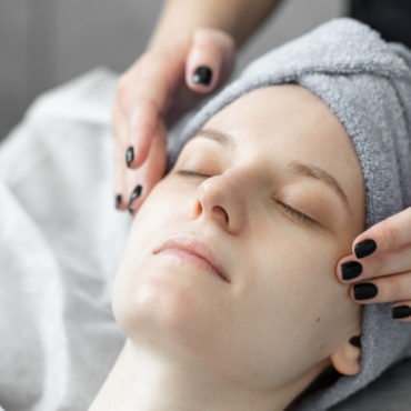 Young beautiful woman doing beauty treatment, massage in the salon.
